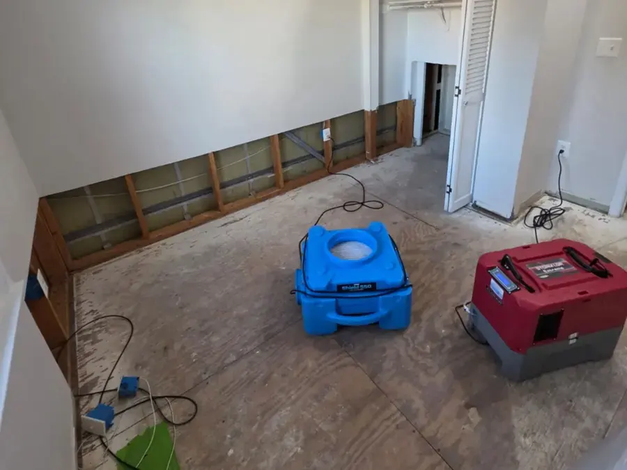 Air movers and a dehumidifier drying a room during a Rockville, MD water damage job