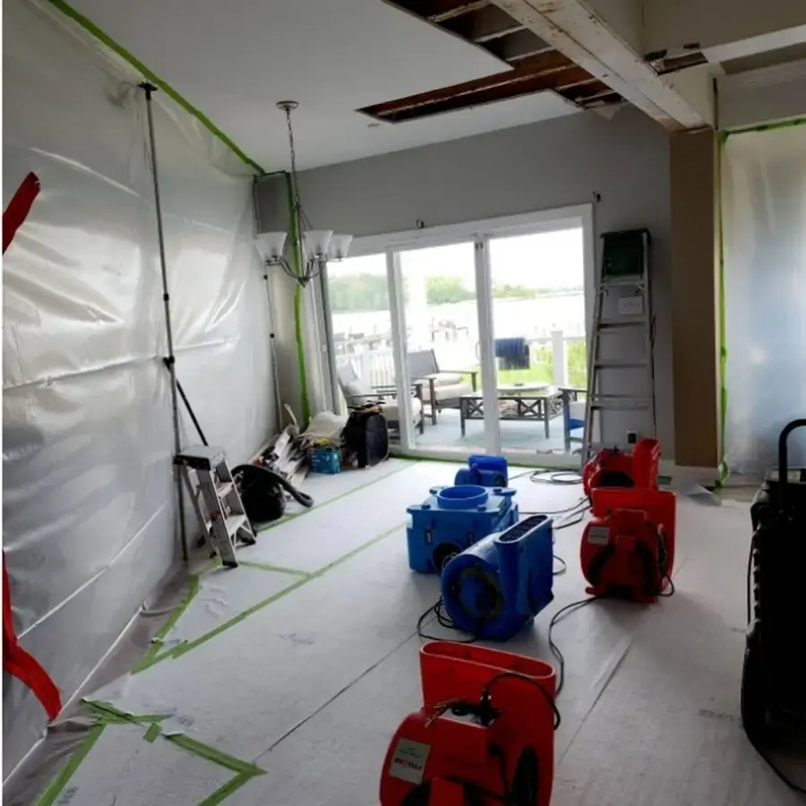 Containment plastic and air movers drying a hallway after a Germantown water leak