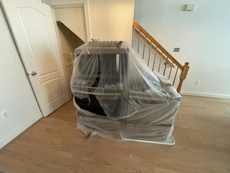 Furniture wrapped in plastic at the foot of the stairs during a Germantown dry-out