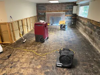 Drying equipment running in a room as part of a Poolesville water damage restoration job